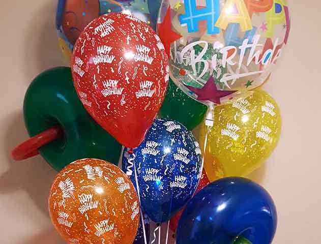 Birthday themed Balloon Bouquet tied to a balloon present design at the bottom