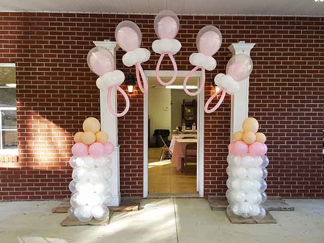 Balloon pacifier arch with balloon baby bottles on the sides