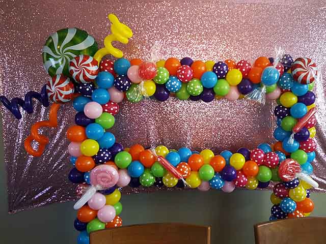 Candy theme photo frame with curly q's, balloon lollipops, and balloon jolly ranchers