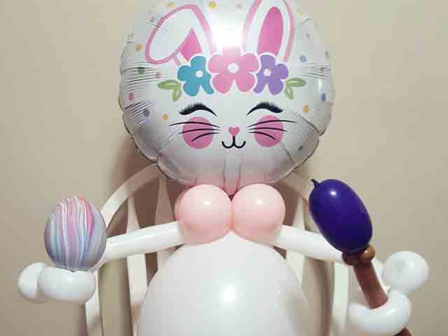 Balloon bunny with an egg and paintbrush