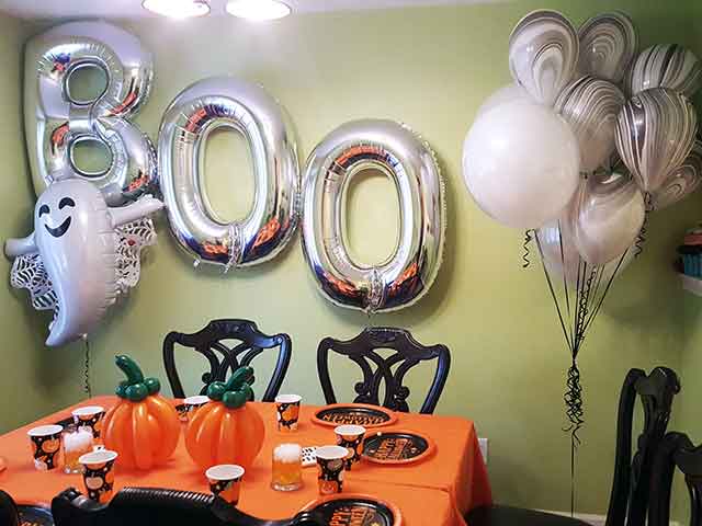 Boo backdrop with a ghost and balloon bouquet